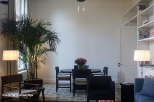 This photo was taken in hotel August in Antwerp, Belgium and features one of the meeting rooms with table, four chairs and a plant.
