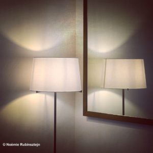 This photo was taken in hotel August in Antwerp, Belgium and features a standing lamp in front of a mirror